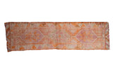 Distressed vintage Kurd runner with faded geometric starburst medallions in orange, pink, beige.