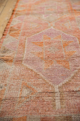Distressed short pile texture and original selvage with tangerine and pink hues.