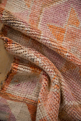 Textural detail of the vintage distressed Kurd runner, showing soft orange and purple pile.