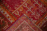 Corner of a Turkish Ghiordes rug folded to show its detailed hand-knotted construction.