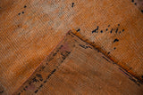 A folded corner on the distressed Kurd runner reveals its hand-knotted foundation.