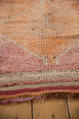 Distressed vintage Kurd runner pile texture in pale raspberry, saffron, beige, with fringed edge.
