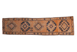 Vintage distressed Kurd runner with geometric navy medallions on an open orange field, 2'10
