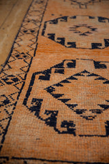 Textured hand-knotted pile of vintage distressed Kurd runner, navy geometric patterns on tangerine.