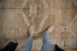 Worn pile of a vintage distressed Oushak rug, with faded beige and pale brown motifs.