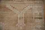 Distressed vintage Oushak rug's textured pile with abrashed beige and ivory.