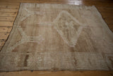 Vintage distressed Oushak rug pile with even wear, featuring muted beige and antique ivory patterns.