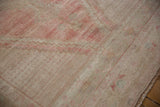 Distressed Oushak rug pile texture with faded blush pink and platinum hues.