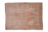 Distressed Oushak prayer rug with a soft, faded palette of dusty rose, silver, and muted greens.