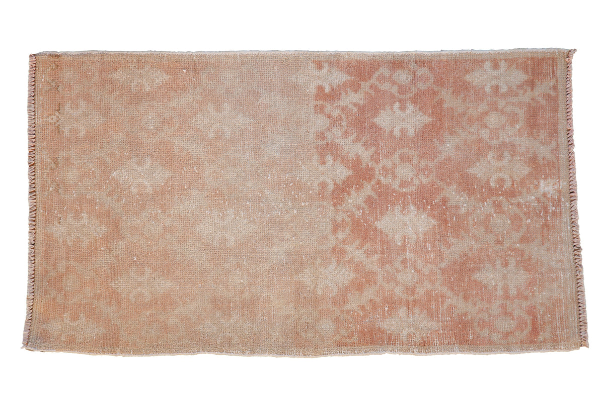 Vintage distressed Oushak rug with a faded trellis pattern in pale copper and antique ivory.