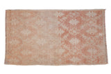 Vintage distressed Oushak rug with a faded trellis pattern in pale copper and antique ivory.