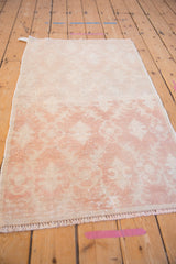 Angled view of a distressed Oushak rug, highlighting the time-softened, low-pile surface.