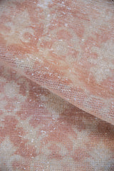Softly distressed hand-knotted pile texture in shades of pale copper and antique ivory.