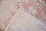 View of a vintage Oushak's hand-knotted back and secured side cord.