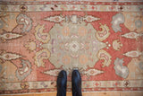 Vintage Distressed Oushak runner, showing worn pile texture, faded brick red and sage green boteh motifs.
