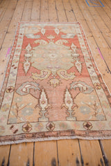 Distressed Oushak runner with cypress tree and boteh motifs, floral border, brick red, pale gold.