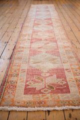 Distressed hand-knotted pile of the vintage Kurd runner, showing raspberry and tangerine geometric details.