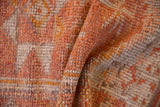 Textured detail of Vintage Distressed Kurd runner pile, displaying worn tangerine, saffron, and ivory hues.