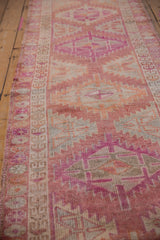 Distressed vintage Kurd runner with worn pile and serrated geometric patterns in dusty red, ivory.