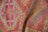 Distressed Kurd runner detail, with worn pile and serrated geometric pattern in soft tones.