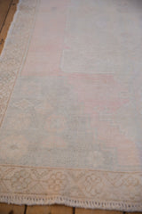 Detail of the distressed pile showing even wear to the knot heads and soft pink colors.