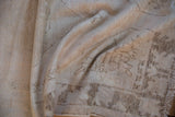 Distressed Oushak rug pile close-up showing worn texture and faded ivory geometric design.