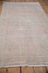 Angled view of the hand-knotted Oushak runner's mostly even wear and abrashed surface.