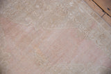 Abrashed dusty mauve and beige wool pile showing even wear to the knot heads.