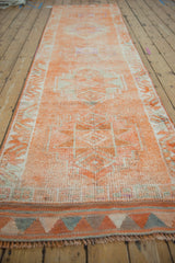 Textured distressed Kurd runner showcasing geometric patterns in tangerine orange, ivory, and silver.
