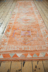 Distressed Kurd runner end with short fringe and tangerine, silver geometric border.