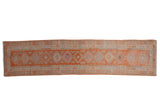 Distressed Kurd runner in tangerine orange with geometric medallions and purple fuchsia floral motifs, 2'7