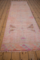 Distressed pink and fuchsia Kurd runner texture, showing low pile and visible knot heads.