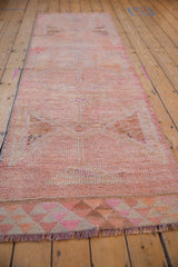 Distressed Kurd runner fringe and geometric triangle border in pink, blush, and melon tones.