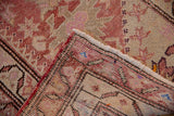 Corner view of a vintage Kurd rug showing the hand-knotted back and distressed, textured pile.