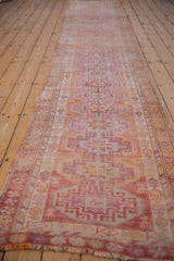 Distressed Kurd runner close-up, featuring geometric guls, hook-and-latch, and fuchsia-orange tones.