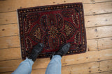 Vintage Sarouk rug overhead, showing central multi-petaled medallion, raspberry red, and navy blue.
