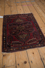 Hand-knotted vintage Sarouk with raspberry multi-petaled medallion and navy floral sprays.