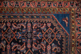 Vintage Hamadan rug corner: navy Herati field, cobalt blue spandrel, and pistachio green, blush borders.