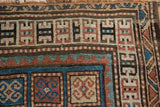 Hand-knotted geometric border of antique Kurdish rug in sky blue, rust, and ivory.