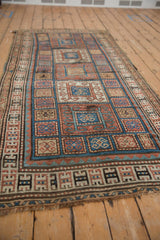 Antique Kurdish runner's field with scrolling rams horn motifs in geometric rust, blue, and ivory.