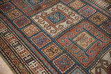 Kurdish runner's geometric border and field with scrolling rams horn motifs in rust and blue.