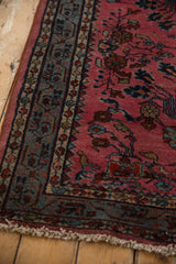 Blue-green mir serbend border and raspberry red floral field of a vintage Lilihan rug.