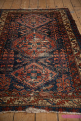 Vintage Mehreban rug's geometric medallion, worn texture, and mahi-mahi patterns in ruby and cobalt.