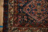 Hand-knotted Mehreban rug detail, showcasing a colorful main border and nuanced plant motifs.