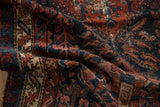 Textured detail of vintage Mehreban rug pile, showing mahi-mahi patterns in gem tones.