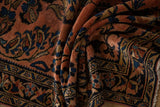 Hand knotted Lilihan runner with folded dusty raspberry and navy ornate floral motifs.