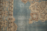 Vintage Sparta carpet's detailed border and abrashed dusty blue field with visible foundation.