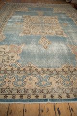 Detail of a vintage hand-knotted Turkish Sparta carpet: abrashed dusty blue field and cream, brown border.