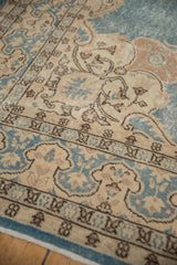 Vintage Sparta carpet: cream spandrel with trefoil motifs, dusty blue field, and border.