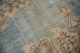 Vintage Sparta carpet, dusty denim blue abrashed field with cream-brown spandrel pattern, showing foundation.